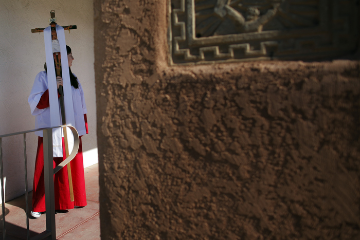 A girl carries out the crucifix after Easter Mass at Our Lady of Guadalupe Catholic Church in Taos, New Mexico March 31, 2013.