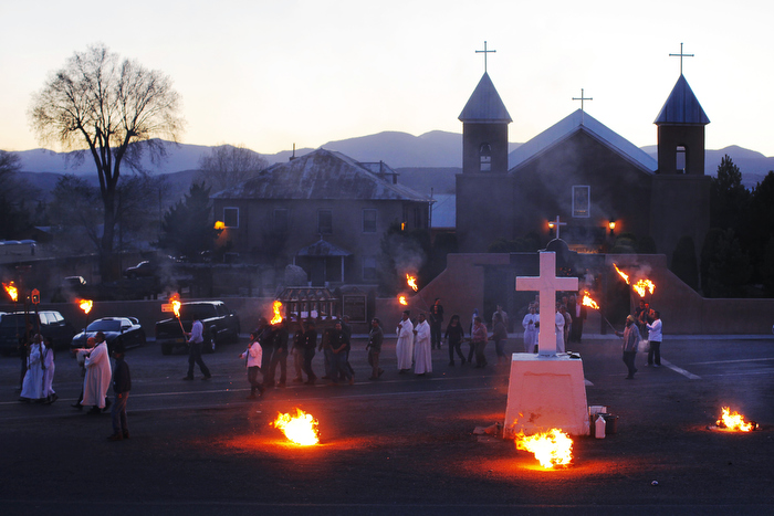 The clergy and the congregation walk in a evening Adoration of the Cross outside the Holy Cross Catholic Church on Good Friday in Santa Cruz, New Mexico March 29, 2013.