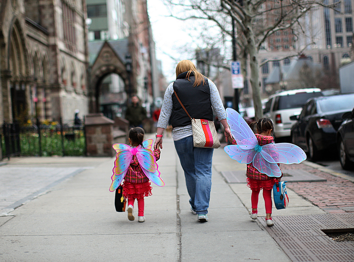 Boston, MA., 04/24/13, It was more than a week before Boylston Street opened up after the Boston Marathon Bombings at the finish line. It was a somber day with people visiting the scene of the terrorist attack. One family dressed their daughters up as angels as they made their way to school on Boylston Street.
