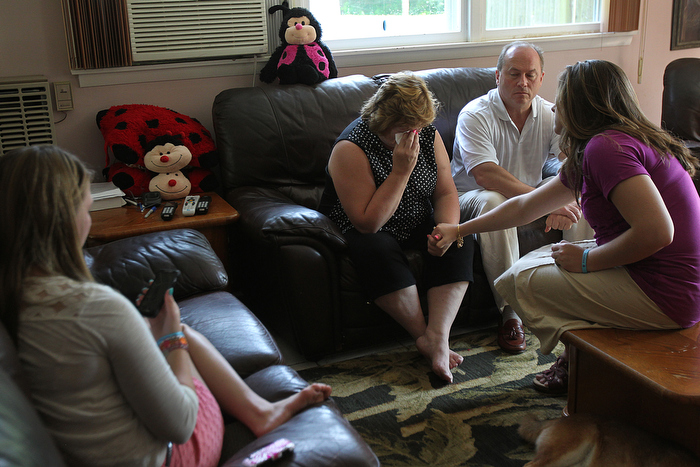 he Pelletier family, Lou and Linda, and their other daughters, learn during a phone call that their daughter, Justina, will be going to foster care. On left is sister Julia who is on phone with Justina. Linda and Lou in center, with sister Jessica on right.
