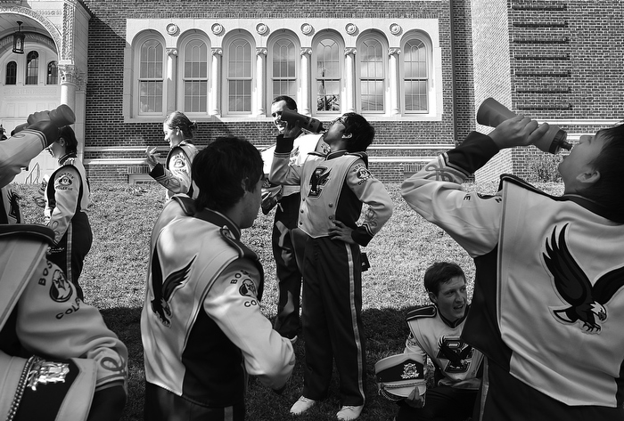 Brighton, MA., 09/19/13, Sometimes the best part of a parade is what happens at the beginning and the end. The Allston Brighton Parade wraps up in Oak Square. The Boston College marching band cooled off at the end of the parade. In center is Taylor Nagai, who plays the bass drum and on right is Sourabh Banthia, who plays the cymbols.