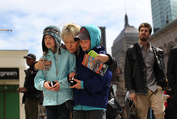 Boston, MA., 04/24/13, Boylston Street opens for the first time to the public since the bombs went off at the finish line of the Boston Marathon. Tanya McIntyre brought her twins Tiana and Colten, 9, down to the site of the first bombing and said a prayer.