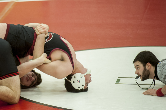 Wellesley wrestler Ned Stabnick (bottom) attempts to regain control in his match against Dedham wrestler Declan Heaslip (top), Dec. 23, 2014.