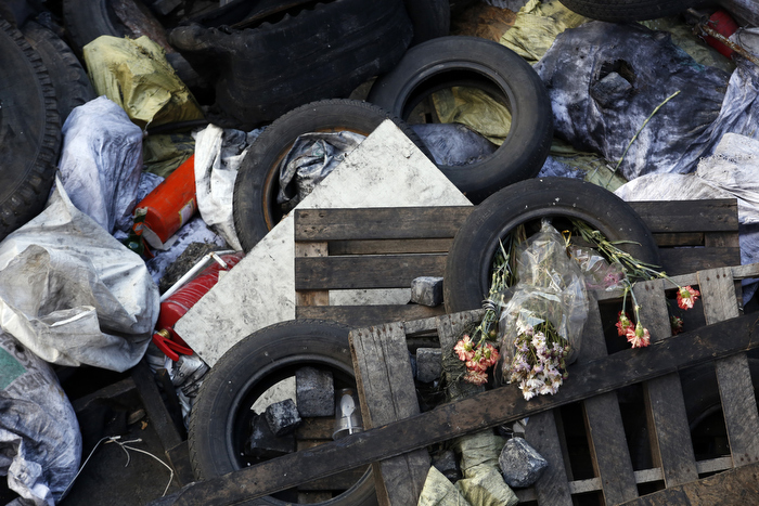 Kiev, Ukraine-- 03/20/2014-- Dried flowers are seen inside of a rubber tire, one of many that make up a giant makeshift barricade inside Maidan in Kiev, Ukraine March 20, 2014.