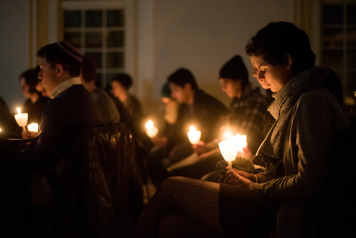 Members of the Tufts community join together in a candlelit moment of silent reflection following the triple homicide of Yusor Mohammad Abu-Salha, her husband Deah Barakat, and her sister Razan Mohammad Abu-Salha.