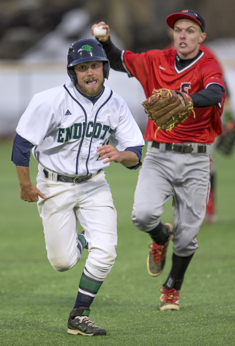 Caught in a rundown while trying to steal second base, Endicott's Cam Farnam is pursued by Eastern Nazarine College's second baseman Jeremy Wagner who threw to first to make the out. Fourth inning action, North Field, Beverly, MA, 3/27.