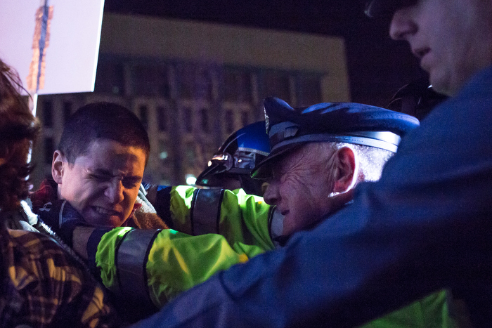 November 25, 2014 – A police officer strangles a man as other protestors attempt to push their way onto the I-93 highway in Boston, Mass.
