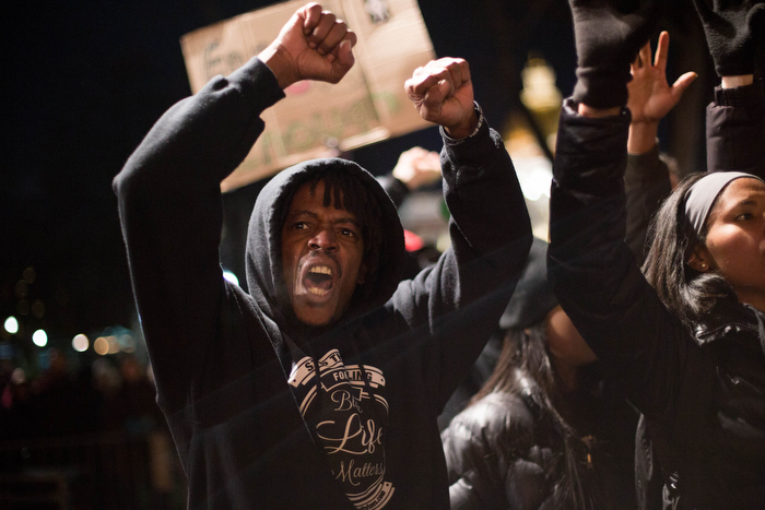 Boston. Dec. 4, 2014. Peter Brown, 50, from Boston, joins the protests against a New York's grand jury decision to not indict Daniel Pantaleo, a white male police officer whose chokehold on Eric Garner, an unarmed black man,resulted in Garner's death.