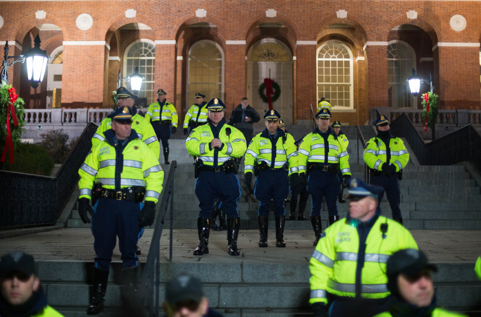 Boston. Dec. 4, 2014. Boston and State police stand behind the Massachusetts State House gates as hundreds gather outside demanding justice for Eric Garner, a black man who died of a chokehold by a white police officer in State Island in July.