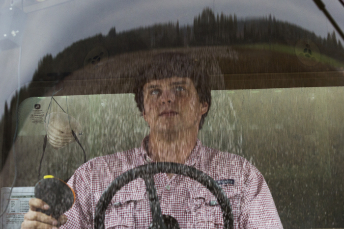 A partially picked field of cotton is reflected in the window of the cab of a picker operated by nineteen year-old Reese Foster at Lee Farm in Bronwood, Georgia October 27, 2015. When Reese is not attending college, he works for Ronnie Lee, who farms 9,000 acres, of which about 5,500 acres are cotton.