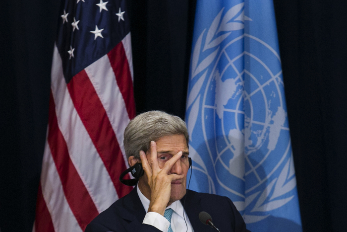 United States Secretary of State John Kerry listens during a meeting with Afghanistan CEO Abdullah Abdullah, Afghanistan Foreign Minister Salahuddin Rabbani, and China Foreign Minister Wang Yi at the Palace Hotel on September 26, 2015, during the United Nations General Assembly in New York.