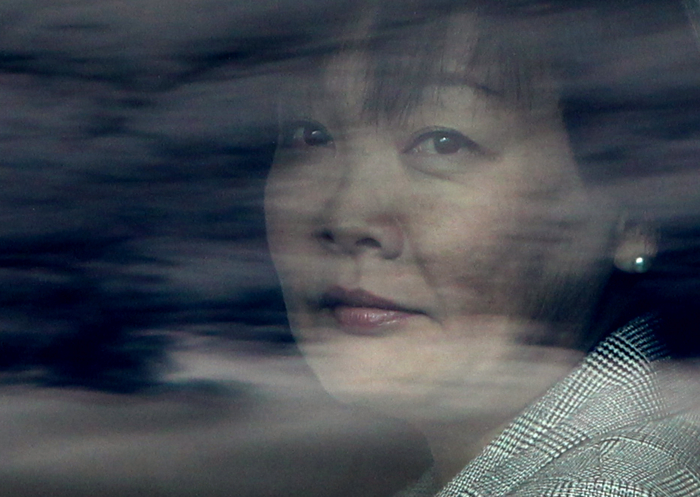 Akie Abe, wife of Japanese Prime Minister Shinzo Abe, is seen through reflections on the window of her limousine just after she and her husband arrived at Logan International Airport in Boston, Mass., Sunday, April 26, 2015. The prime minister and first lady visited the Boston Marathon Bombing site during their trip.