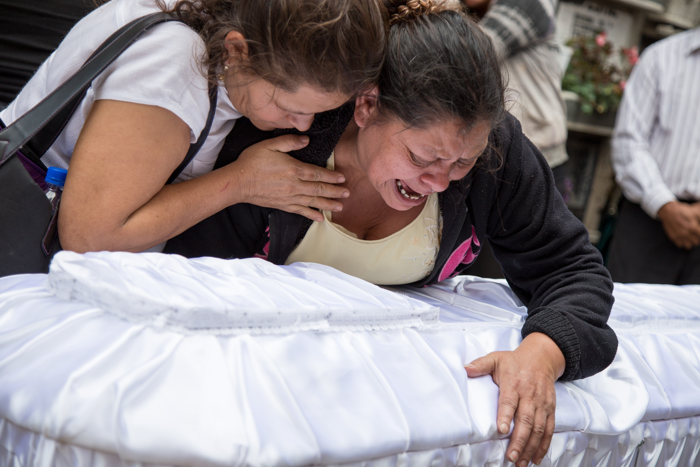 Mother of Rosa Julia Tobar cries over her daughter's coffin during funeral ceremony. Rosa was one of at least 40 girls killed in the Virgen de la Asuncin fire in Guatemala City this past March.