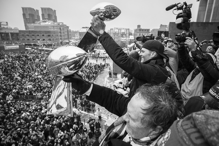 New England Patriots quarterback Tom Brady raises Super Bowl trophies along with head coach Bill Belichick during a victory parade in Boston on Feb. 7, 2017, following the Patriots' win over the Atlanta Falcons in the NFL Super Bowl 51.