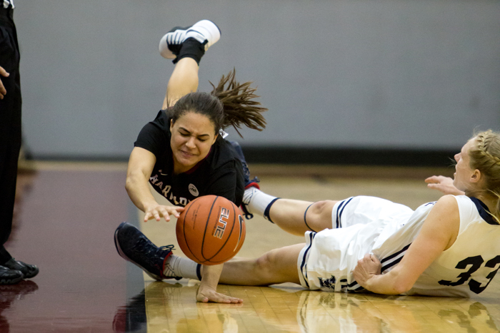 Katie Benzan (Harvard) falling after being tripped up in an Ivy League Conference matchup versus Yale. Harvard won the game 76-56.