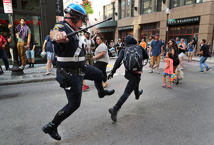 Boston-8/19/17 A Boston Police officer chases a protestor down Washington Street in Downtown Crossing with his baton out. He caught him and the protestor was subdued and arrested. This, after a Free Speech rally was held on Boston Common. - Photo by John Tlumacki / The Boston Globe